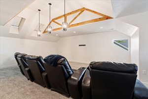 Carpeted cinema with vaulted ceiling