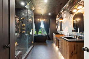 Bathroom featuring tile patterned floors, vanity, a textured ceiling, and walk in shower