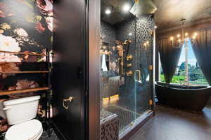 Bathroom with a textured ceiling, toilet, a notable chandelier, a shower with shower door, and tile patterned floors