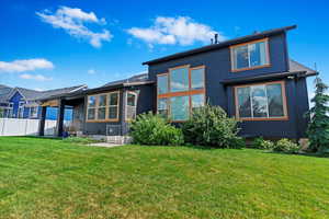 Rear view of house with a lawn