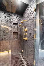 Bathroom featuring a tile shower