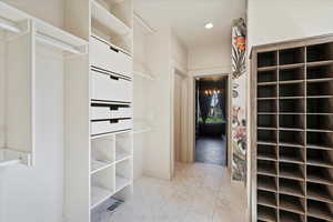 Spacious closet featuring light tile patterned flooring