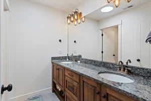 Bathroom featuring double sink vanity and tile patterned floors