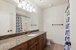 Bathroom with tile patterned floors, vanity, and toilet