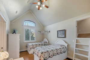 Bedroom featuring lofted ceiling, light wood-type flooring, and ceiling fan