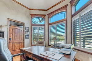 Office area with crown molding, hardwood  flooring, separate entrance from front porch, and a healthy amount of sunlight