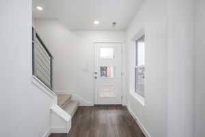 Foyer with dark wood-type flooring