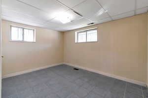 Bedroom #1 Basement with a paneled ceiling and tile-patterned floors