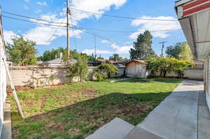 View of yard with a storage unit