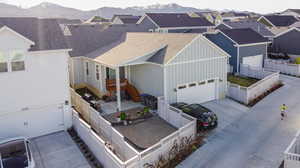 View of front of property featuring a garage and a mountain view