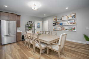 Dining area with light hardwood / wood-style flooring