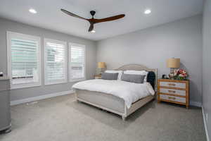 Carpeted bedroom with ceiling fan