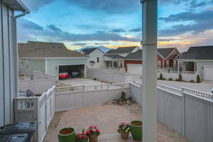 Patio terrace at dusk with a garage