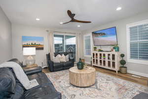 Living room with hardwood / wood-style floors and ceiling fan