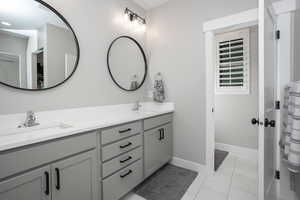 Bathroom featuring dual vanity and tile patterned flooring