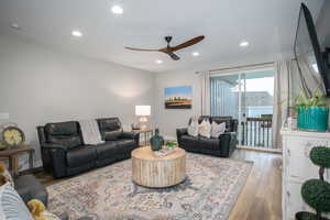 Living room with ceiling fan and light hardwood / wood-style flooring