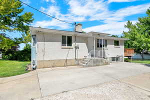 View of front of home featuring a front yard and a wooden deck