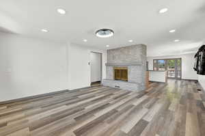 Unfurnished living room featuring a fireplace and hardwood / wood-style flooring