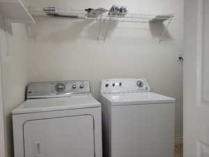 Clothes washing area featuring washer and clothes dryer