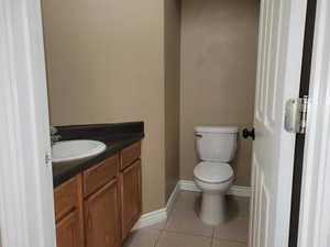 Bathroom featuring tile patterned flooring, vanity, and toilet