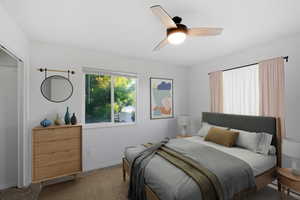 Bedroom featuring ceiling fan and carpet. This bedroom is virtually staged.