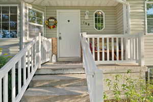 Entrance to property featuring a porch