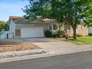 View of front of home with a garage & RV parking