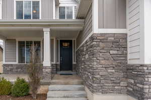 View of exterior entry featuring covered porch