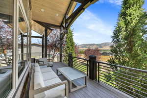 Deck featuring a mountain view and an outdoor living space