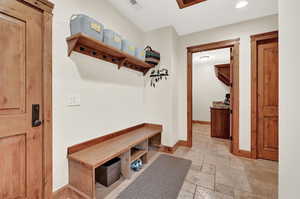 Mudroom with light tile patterned flooring