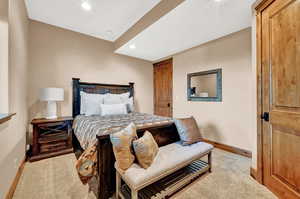 Bedroom featuring light colored carpet