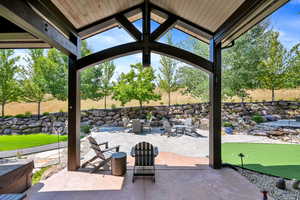 View of patio with an outdoor fire pit