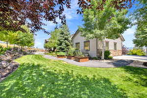 View of side of home with a lawn