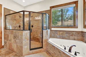 Bathroom featuring tile patterned flooring and separate shower and tub