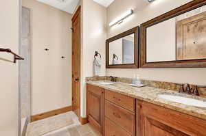 Bathroom featuring tile patterned flooring and dual vanity