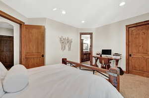 Bedroom with carpet flooring and ensuite bath