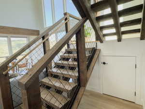 Staircase featuring hardwood / wood-style floors