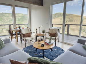 Living room featuring light hardwood / wood-style flooring, a wealth of natural light, and a mountain view