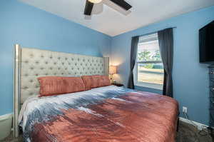 Carpeted bedroom with ceiling fan