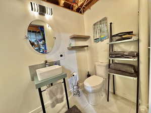 Bathroom with sink, tile patterned flooring, and toilet