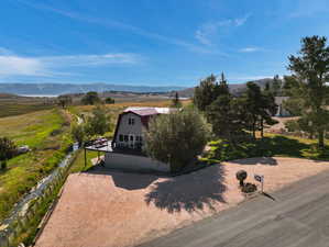 View of front of home with a mountain view and a rural view