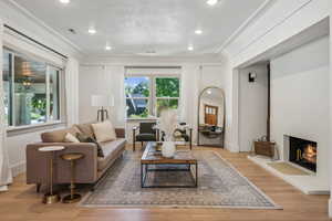 Living room featuring crown molding and light hardwood / wood-style flooring