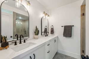 Bathroom featuring vanity, walk in shower, and tile patterned floors