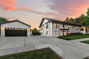 Modern farmhouse featuring a lawn and a garage