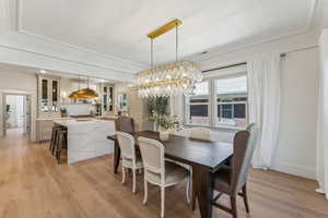 Dining room featuring an inviting chandelier and light hardwood / wood-style flooring