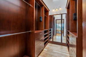 Walk in master closet with custom cabinetry