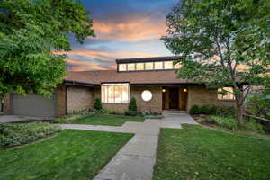 View of front of house with a garage and a lawn