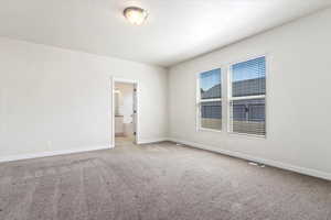 Empty room with light colored carpet