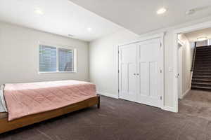 Bedroom featuring carpet floors and a closet