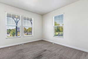 Carpeted empty room with plenty of natural light